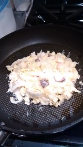 Frying the okonomiyaki batter with cabbage.