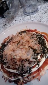 Bonito flakes top off the okonomiyaki. 
