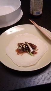 Wrapper with crispy duck skin, green onion, and hoisin sauce. 